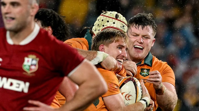 Australia's Tate McDermott celebrates a try with teammates during the third rugby test match between Australia and the British and Irish Lions. Photo / AFP