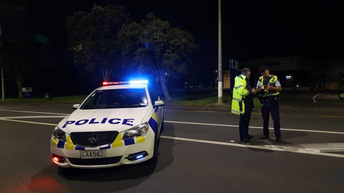 Police in Mt Wellington last night, where a man was found with a gunshot wound in one of his arms. (Photo / Hayden Woodward)