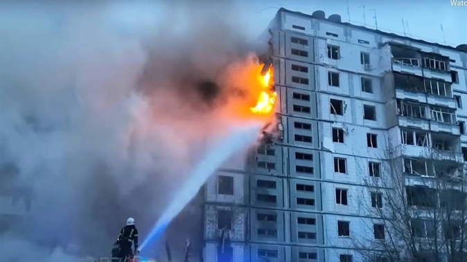 In this image taken from video provided by the National Police of Ukraine, firefighters work at an apartment building destroyed by a Russian attack in the town of Uman. Photo / AP