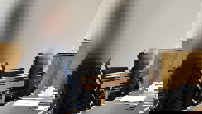 An Auckland businessman accused of assaulting a woman in March 2022 sits in court on the first day of his trial in the Auckland District Court on November 26, 2024. Photo / George Block