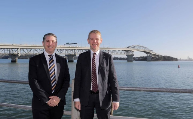 Transport Minister Michael Woods and Prime Minister Chris Hipkins in front of the Auckland Harbour Bridge. Photo / Michael Craig