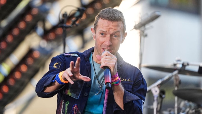 Chris Martin was pictured kissing the tarmac before boarding a flight to Auckland yesterday. Photo / Getty Images