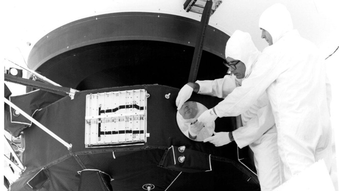 Engineers can be seen securing the cover over the Voyager 1 Golden Record in 1977.
