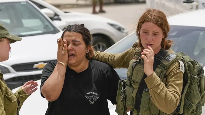 An Israeli soldier cries outside a military base following a deadly shootout in southern Israel. Photo / AP