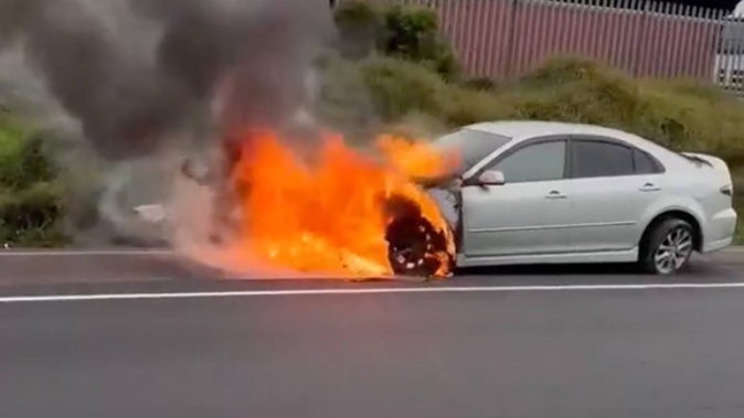 Flames engulf the hood of a car on Auckland's Southern Motorway.