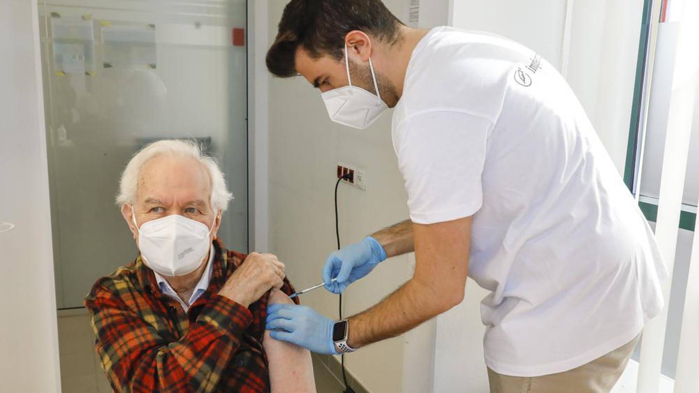 Kurt Switil, left, receives a Pfizer vaccination against the coronavirus in Vienna. Photo / AP
