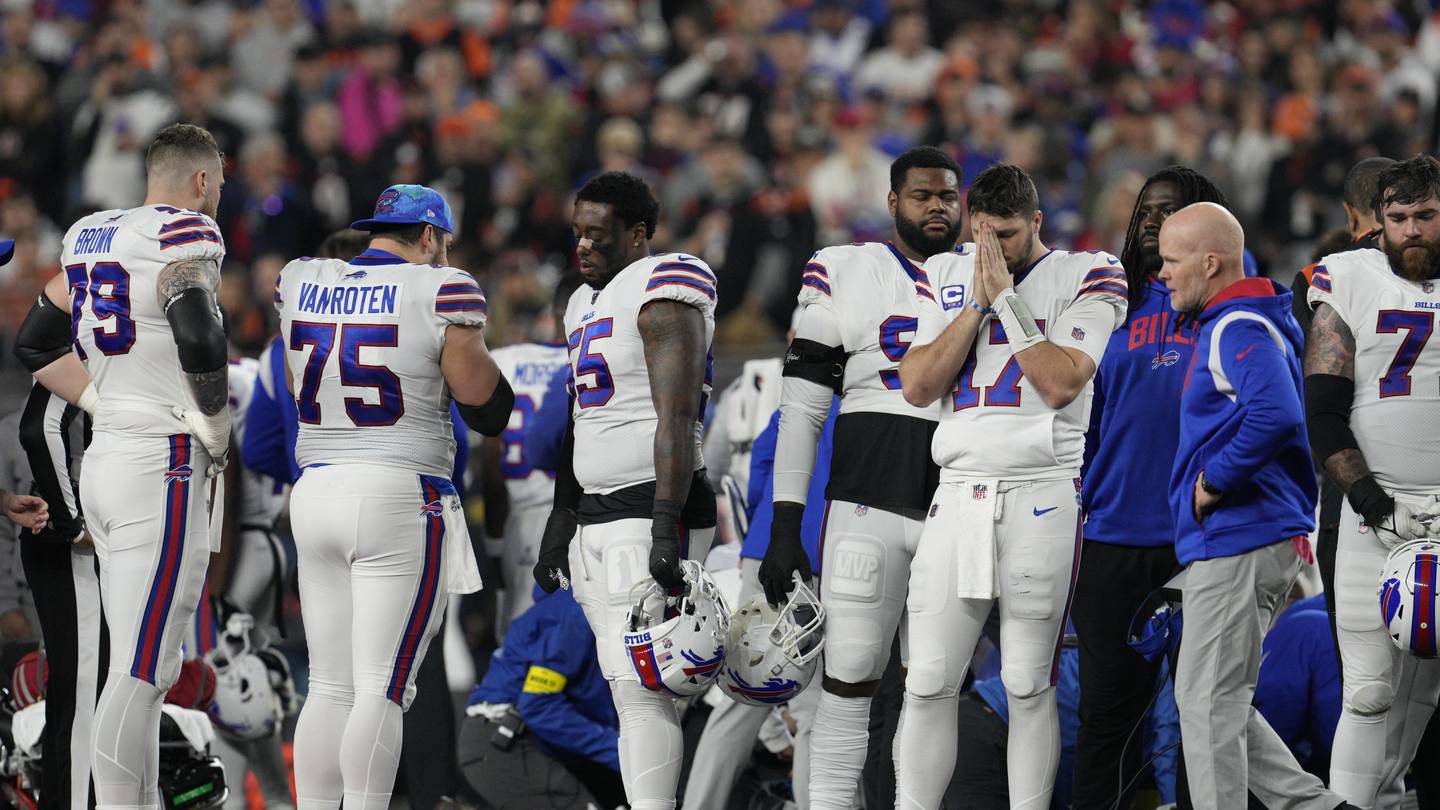Buffalo Bills players look on as Damar Hamlin is given medical assistance on the field. Photo / AP