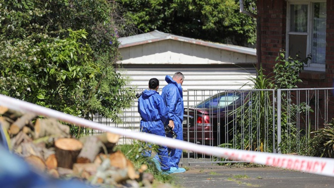 Police examine the property where Derek McFarland was killed in November 2020. Photo / Hayden Woodward