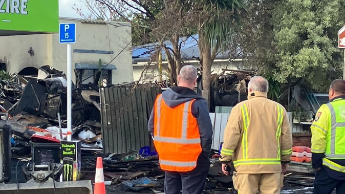 A Frederick St home surrounded by piles of hoarded goods went up in flames in Hastings on Saturday morning. Photo / NZME