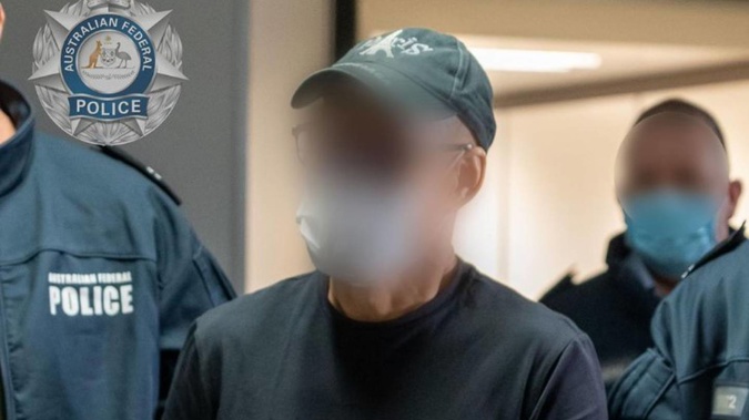 Australian Federal Police escort Chung Chak Lee at Melbourne airport on June 11. Photo / Supplied