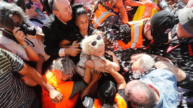 Kellie-Jay Keen-Minshull aka Posie Parker had liquid, believed to be soup, thrown at her as she attempted to make her way to the rotunda at Albert Park, Auckland. March 25, 2023 Photo / Dean Purcell