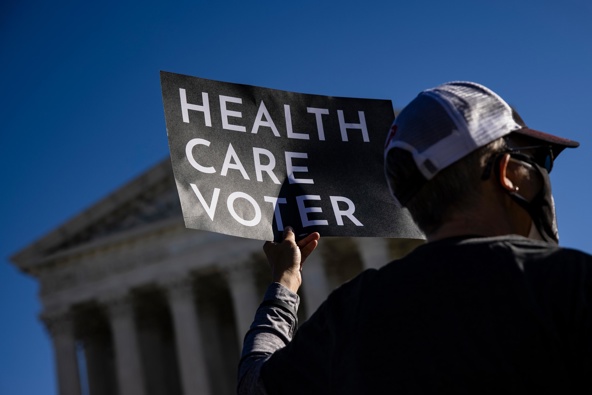A supporter of the Affordable Care Act (ACA) stands in front of the Supreme Court of the United States in 2020. Photo / Getty Images