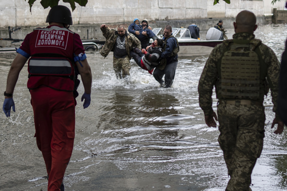 Emergency teams help rush to safety injured civilian evacuees who had came under fire from Russian forces while trying to flee by boat from the Russian-occupied east bank of a flooded Dnieper River to Ukrainian-held Kherson, on the western bank in Kherson, Ukraine on Sunday, June 11, 2023. Photo / AP