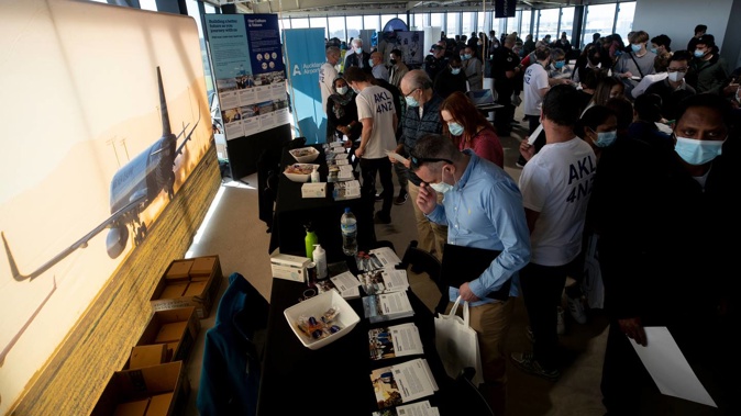 Hundreds of people line up to attend the Auckland Airport Job Fair. Photo / Dean Purcell