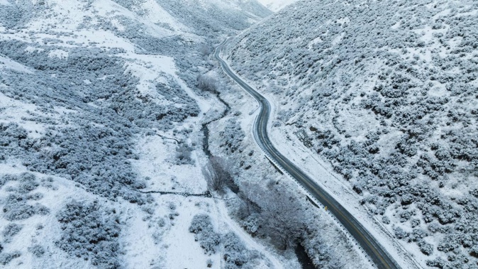 An incoming system is set to deliver widespread wind and rain this week – and a potential heavy dump of snow affecting routes like Crown Range Rd (pictured). Photo / George Heard