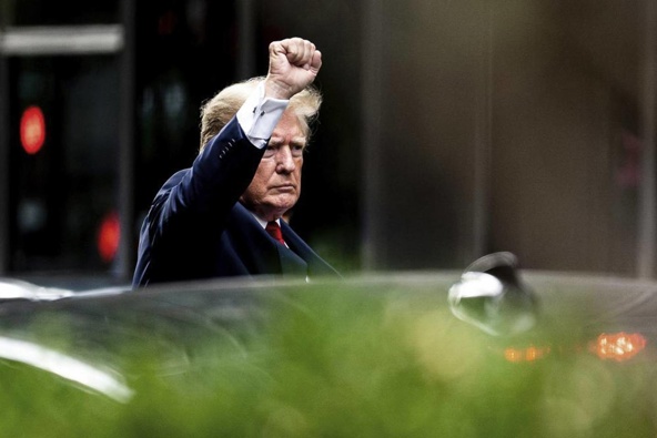 Former President Donald Trump waves as he departs Trump Tower. Photo / AP