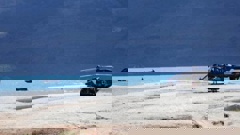 A rescue helicopter sits on a sandbar amid the emergency services response. Photo / Rhyva Van Onselen
