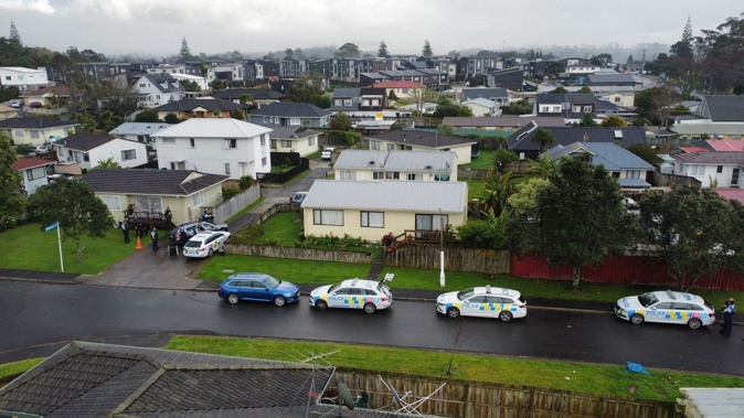 Armed police swarmed Glen Eden in West Auckland this morning to put in custody a parolee being returned to jail. The man was at a property in Selak Place. Photo / Supplied