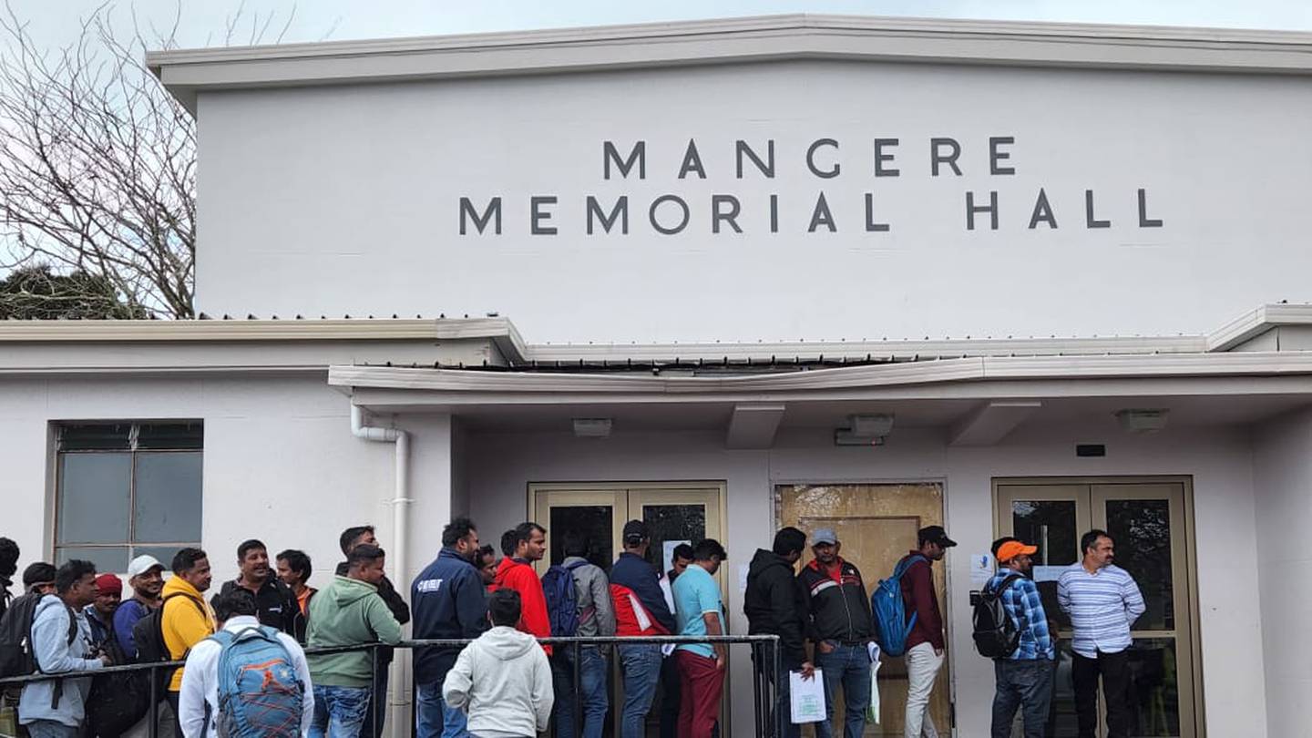 Migrant workers line up outside the Māngere Memorial Hall waiting for interviews. Photo / RNZ