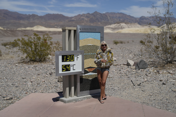 A woman poses by a thermometer, Sunday, July 16, 2023, in Death Valley National Park, Calif. Photo / AP