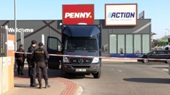 Czech police near a police cordon in front of an Action discount shop in Hradec Kralove, Czech Republic, where in the morning a teenager killed two women in a knife attack. Photo / AFP