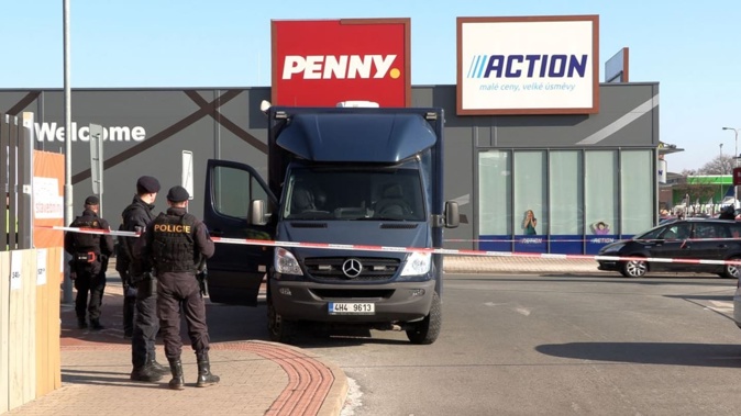 Czech police near a police cordon in front of an Action discount shop in Hradec Kralove, Czech Republic, where in the morning a teenager killed two women in a knife attack. Photo / AFP