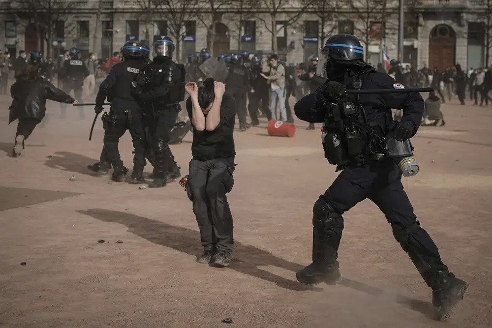  Police officers scuffle with protesters during a demonstration in Lyon, central France, on March 23, 2023. French authorities see the police as protectors ensuring that citizens can peacefully protest President Emmanuel Macron’s contentious retirement age increase. But to human rights advocates and demonstrators who were clubbed or tear-gassed, officers have overstepped their mission.  (AP Photo/Laurent Cipriani, File)