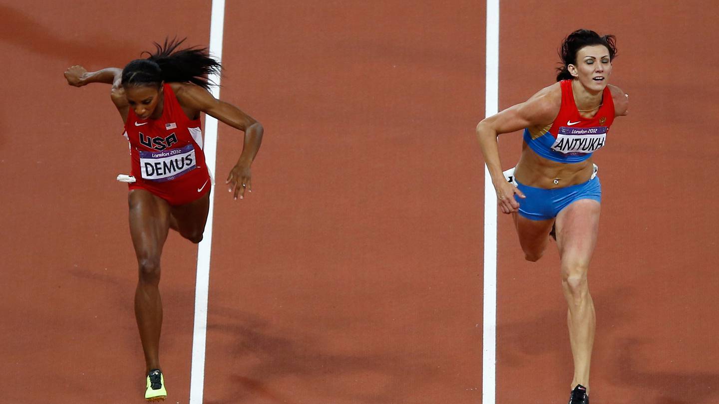 Russia's Natalya Antyukh, right, powers ahead of United States' Lashinda Demus to win gold in the women's 400-metre hurdles final during the athletics in the Olympic Stadium at the 2012 Olympics, London. Photo / AP