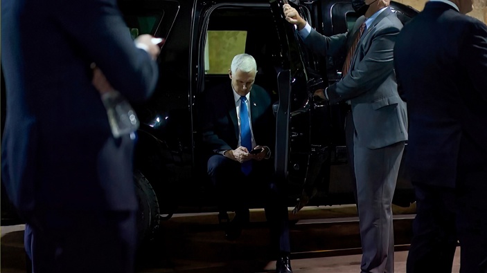 In this image from video released by the House Select Committee, Vice President Mike Pence looks at a phone from his secure evacuation location on Jan. 6 that is displayed as House select committee investigating the Jan. 6 attack on the U.S. Capitol holds a hearing Thursday, June 16, 2022, on Capitol Hill in Washington. (Photo / AP)