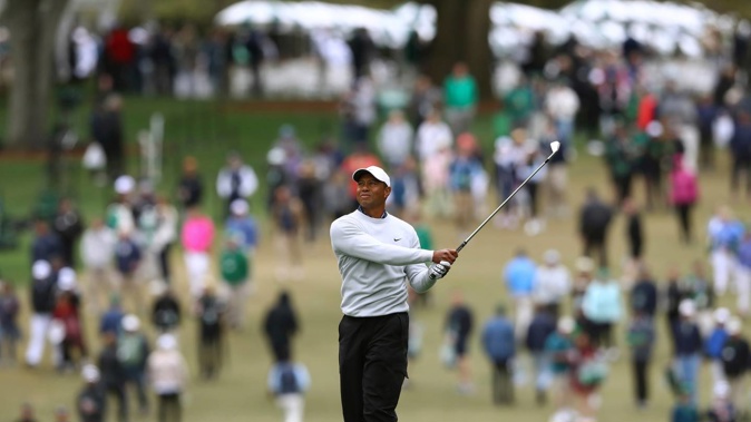Tiger Woods watches his second shot on the first hole during the third round of the Masters. Photo / AP