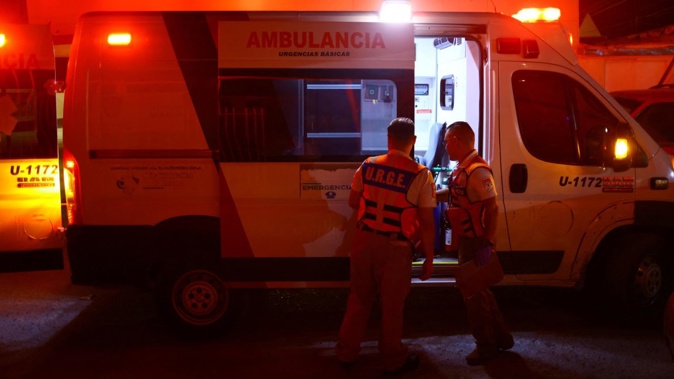 Paramedics stand near an ambulance after treating an older person with symptoms of dehydration during a day of high temperatures in Ciudad Juarez, Mexico, on June 27, 2023. Jose Luis Gonzalez/Reuters