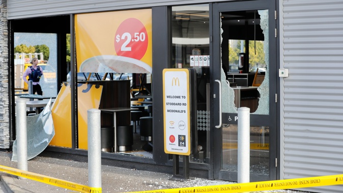 Police on scene at the McDonald’s on Stoddard Rd where all of the glass windows have been smashed. Photo / Dean Purcell