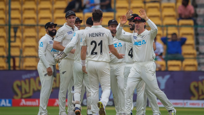 New Zealand players celebrate the wicket of Sarfaraz Khan of India during day two of the First Test match between India and New Zealand at M. Chinnaswamy Stadium on October 17, 2024 in Bengaluru, India. (Photo by Abhishek Chinnappa/Getty Images)