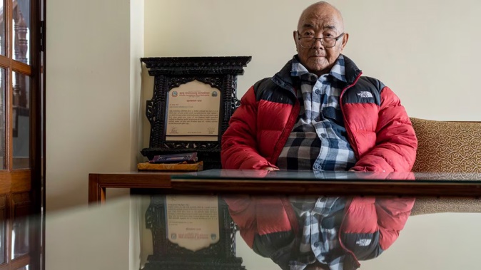 Kanchha Sherpa sits on a chair during an interview with Associated Press at his residence in Kathmandu, Nepal. Photo / AP