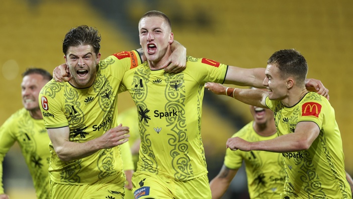Finn Surman celebrates with Alex Rufer and Ben Old after scoring a goal during the A-League Men round 24 match between Wellington Phoenix and Melbourne Victory. Photo / Getty