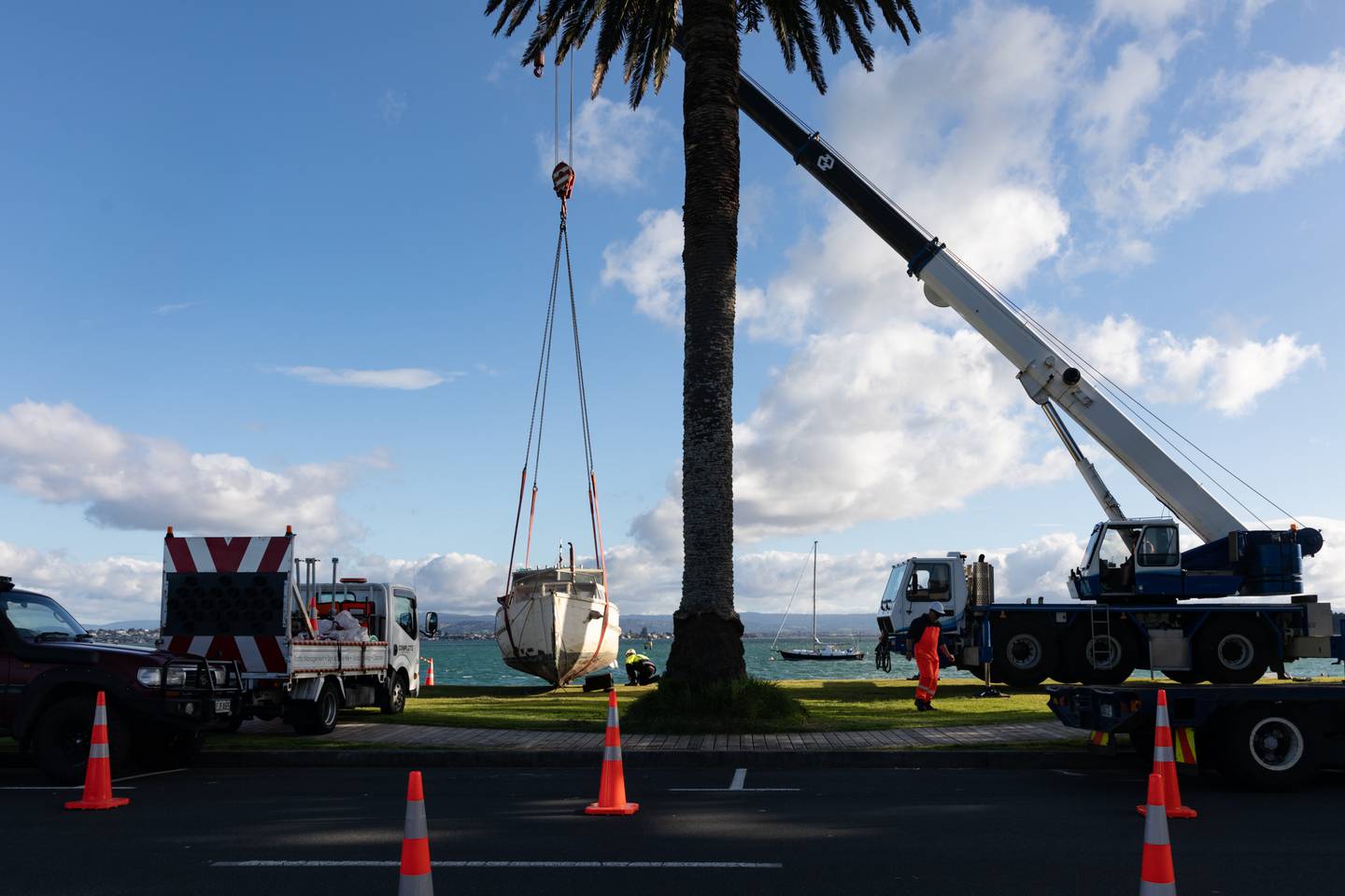A large crane was used to lift Brian Currie’s boat, the Hauraki, off the beach at Pilot Bay on July 10. Photo / Alex Cairns