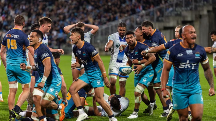 Moana Pasifika players celebrate their win over the Blues. Photo / Photosport