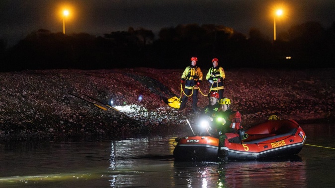 Emergency services searching the Avon River in Christchurch after a car was found submerged this evening. Photo / George Heard