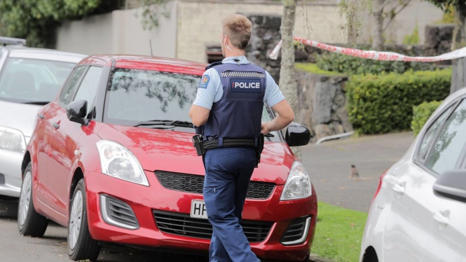 Police investigate the scene at Saint Vincent Ave, Remuera, where a woman was found dead in this red Suzuki Swift car. (Photo / Michael Craig)