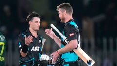Mark Chapman and Jimmy Neesham celebrate New Zealand's win. (Photo / AP)
