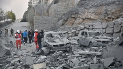 Rescue teams stand next to damaged cars at the site of an Israeli airstrike that targeted the village of Baalshmay in the Lebanese mountains, east of Beirut, on November 12, 2024. Photo / AFP
