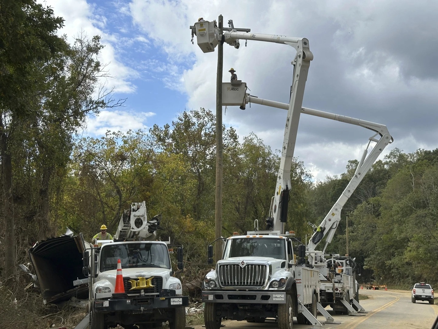 Contractors rebuild destroyed electrical lines near the Swannanoa River in Asheville, North Carolina. Photo / AP