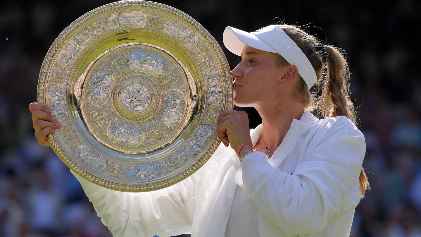 Kazakhstan's Elena Rybakina kisses the trophy as she celebrates after beating Tunisia's Ons Jabeur to win the final of the women's singles at Wimbledon. Photo / AP