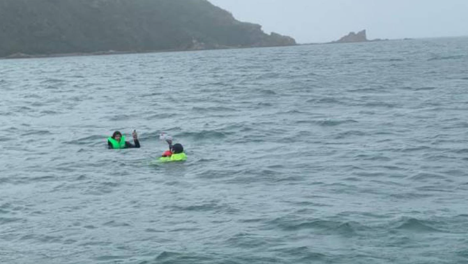 Two people - both wearing lifejackets - were rescued after their boat sank. (Photo / Supplied)