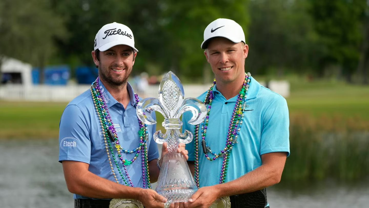 Davis Riley, left, and teammate Nick Hardy hold their trophy after winning the PGA Zurich Classic. Photo / AP