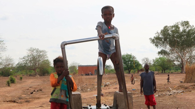 Children play on a water pump in an internally displaced camp in Gaoa, Burkina Faso. (Photo / AP)