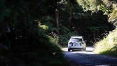 Fire investigators and police at the scene of the house-bus fire on Blue Spur Rd, Hokitika. Photo / George Heard