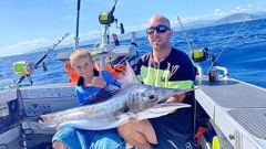 Cohen Snell, pictured with his dad Ben, was keen to tell his friends at school about his world record catch, something they said was "pretty cool". Photo / Supplied