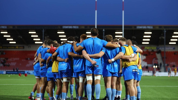Worcester Warriors players huddle on the pitch ahead of warm ups prior to the Premiership Rugby Cup match between Gloucester and Worcester Warriors. Photo / Getty