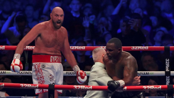 Britain's Tyson Fury, left, celebrates after beating Britain's Dillian Whyte during their WBC heavyweight title boxing fight at Wembley Stadium in London. Photo / AP